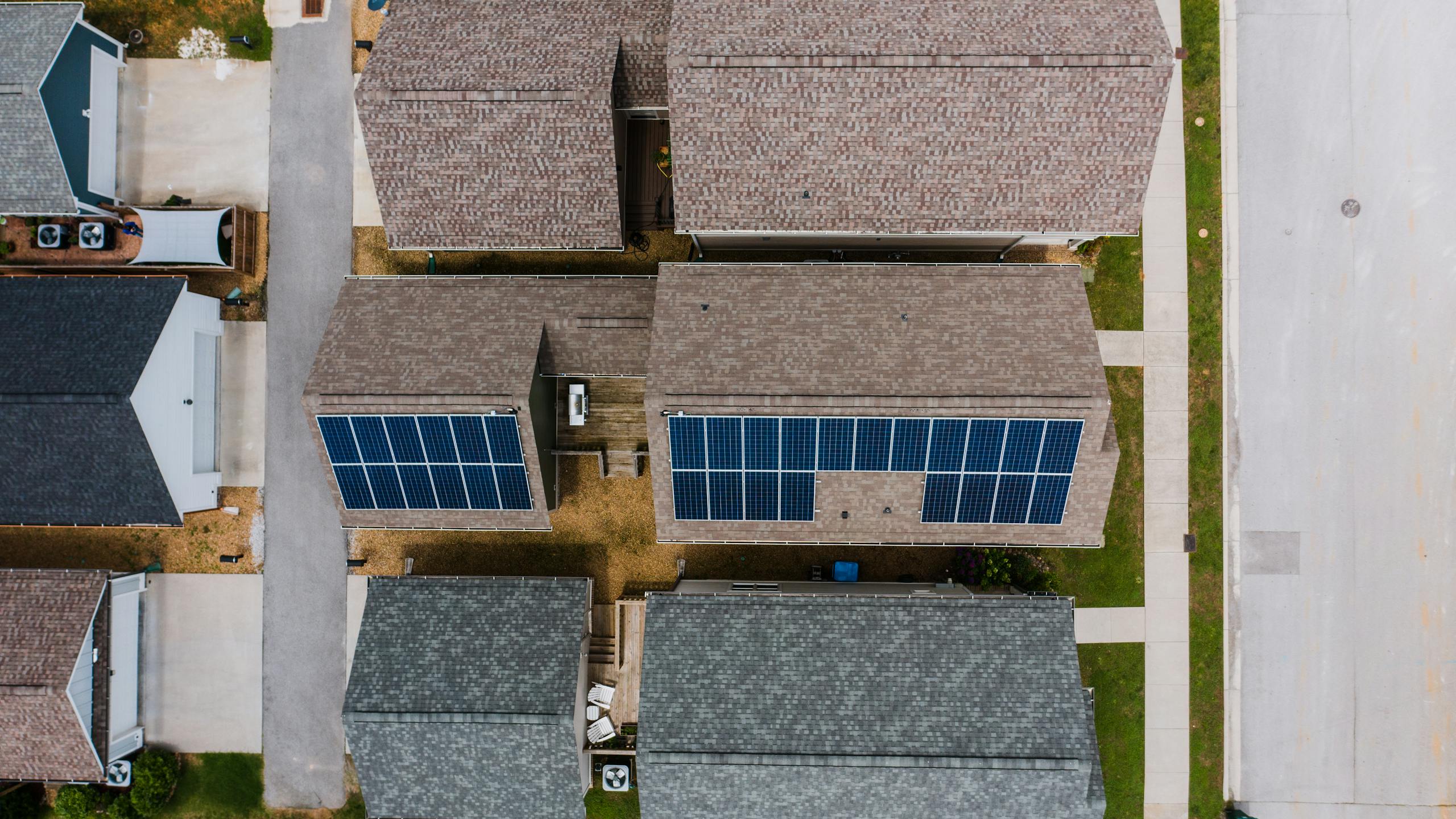 Homes with solar panels on roofs - renewable energy use