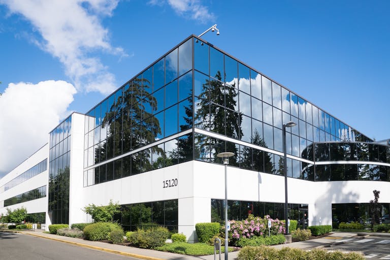 Leasing Commercial Property - Office Building with reflective glass on a sunny day